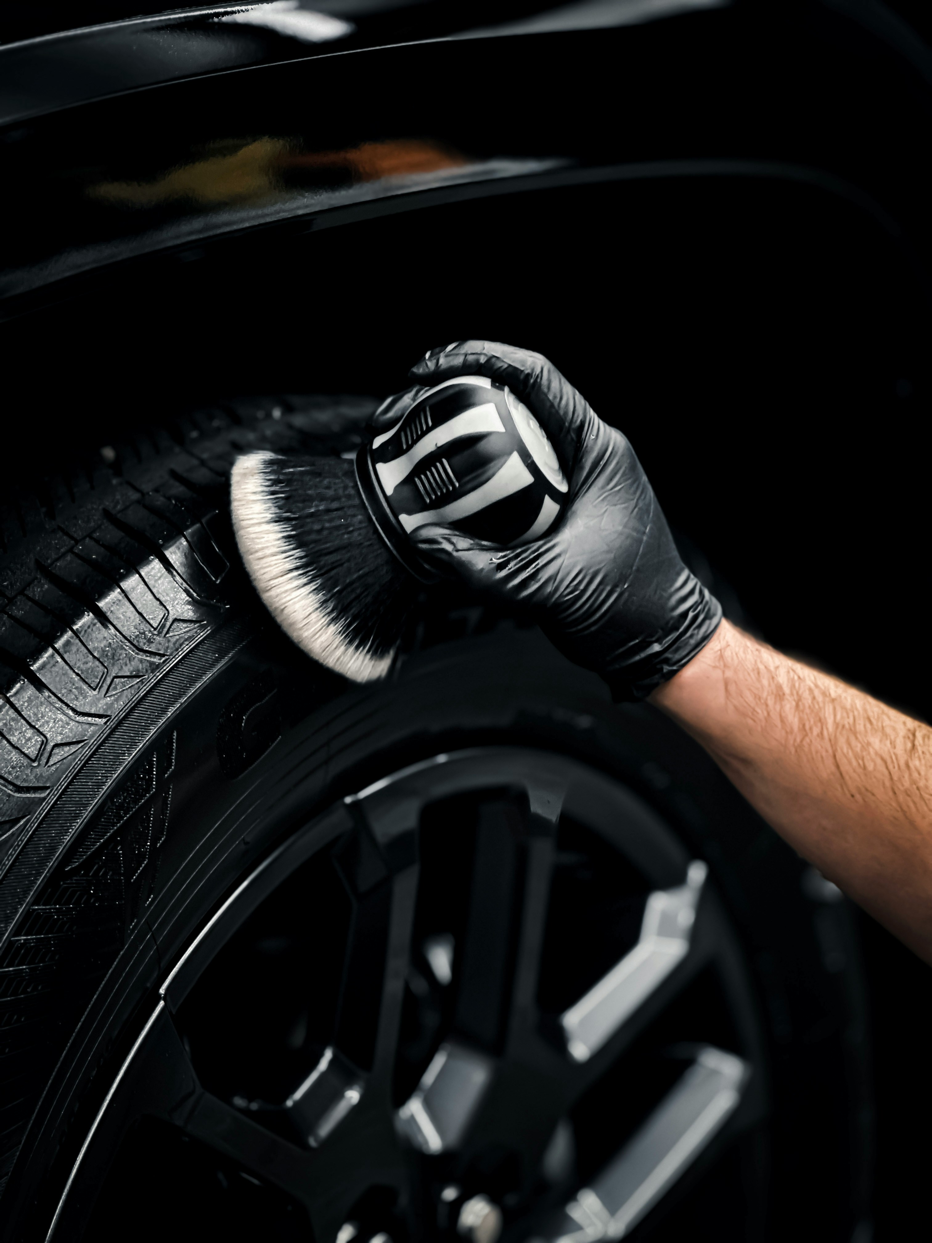 Professional mobile detailer gloved hands at work